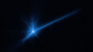 A photo of athe dust plume and tail of asteroid Dimorphos after the DART collision