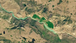 Satellite photo of a river that has swelled up to a point before stopping completely