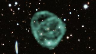 a green circle of light against a background of stars