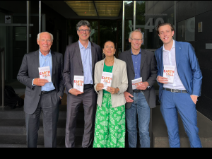 The author team of The Earth for All report presenting the newly published report during the press conference. Jorgen Randers standing on the left side of the group.